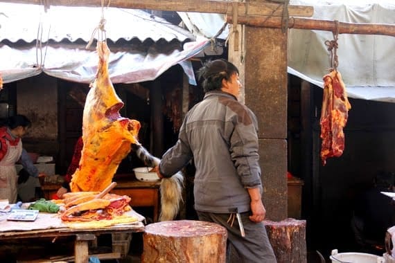 You Know You're in China When.... 13 Chinese butcher holding a tail